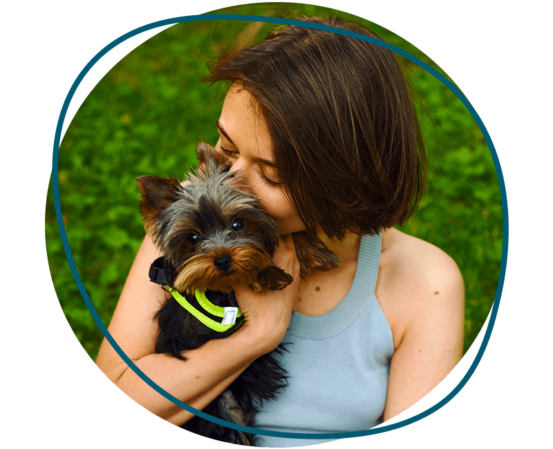 cute girl hugging her yorkshire terrier dog
