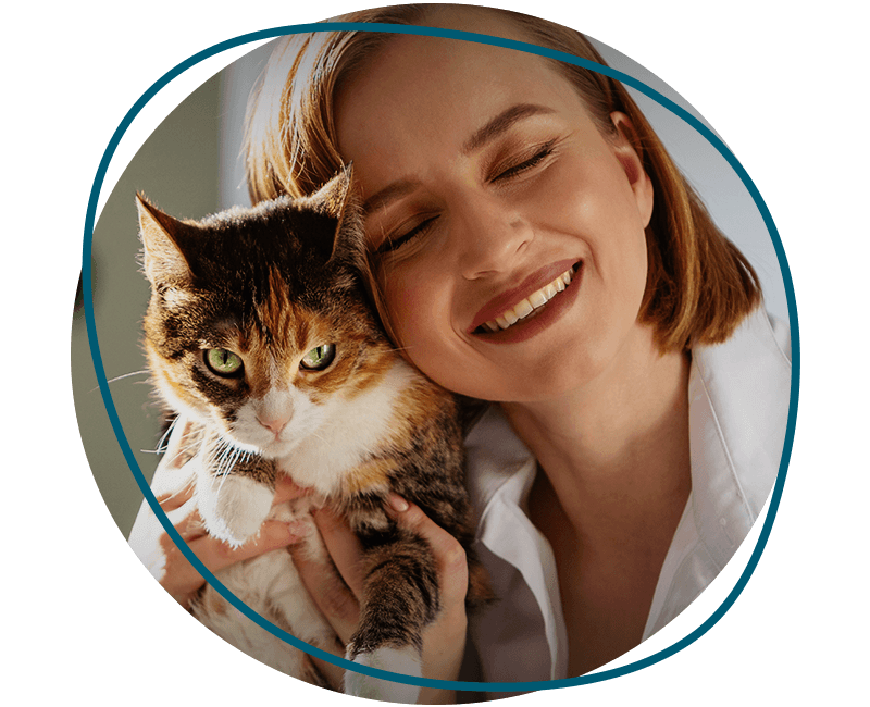 smiling woman hugging a cat