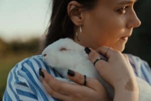Woman cradling her rabbit that has been breathing too fast